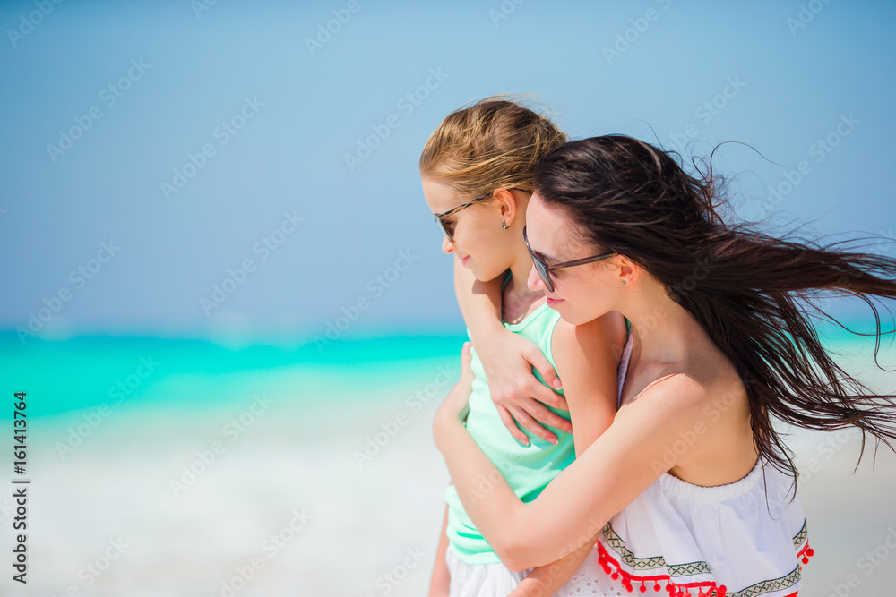 Happy family of mother and little girl at tropical beach Happy family of mother and little girl at tropical beach