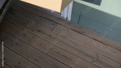 A female picks up a package from outside his front door