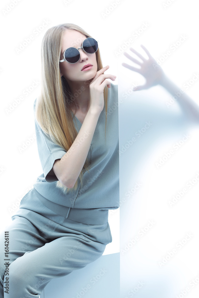Fashion model in sunglasses, beautiful young woman.