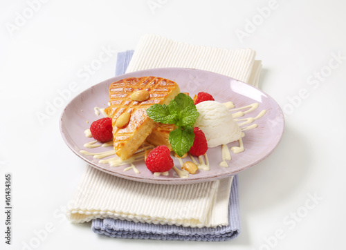 Almond cake with ice cream and raspberries photo