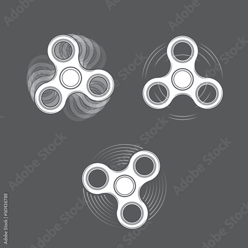 Set of white spinning fidget spinners on gray background