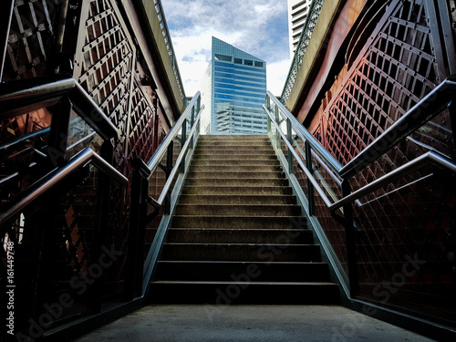 Dark stairs leading up into open air in downtown city