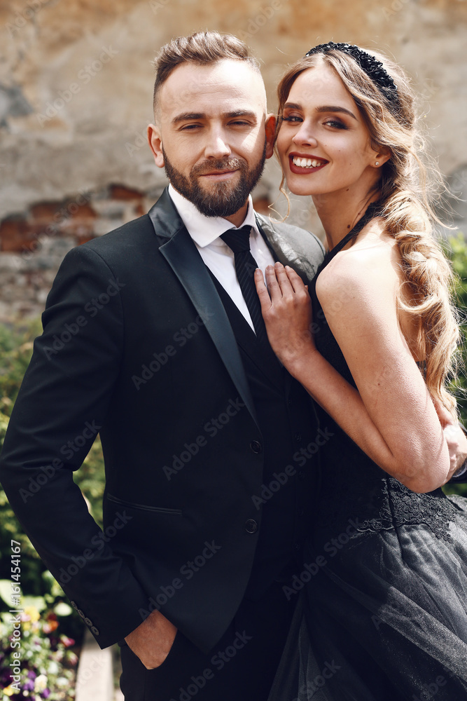 Woman leans to her bearded man posing outside Woman leans to her bearded man posing outside