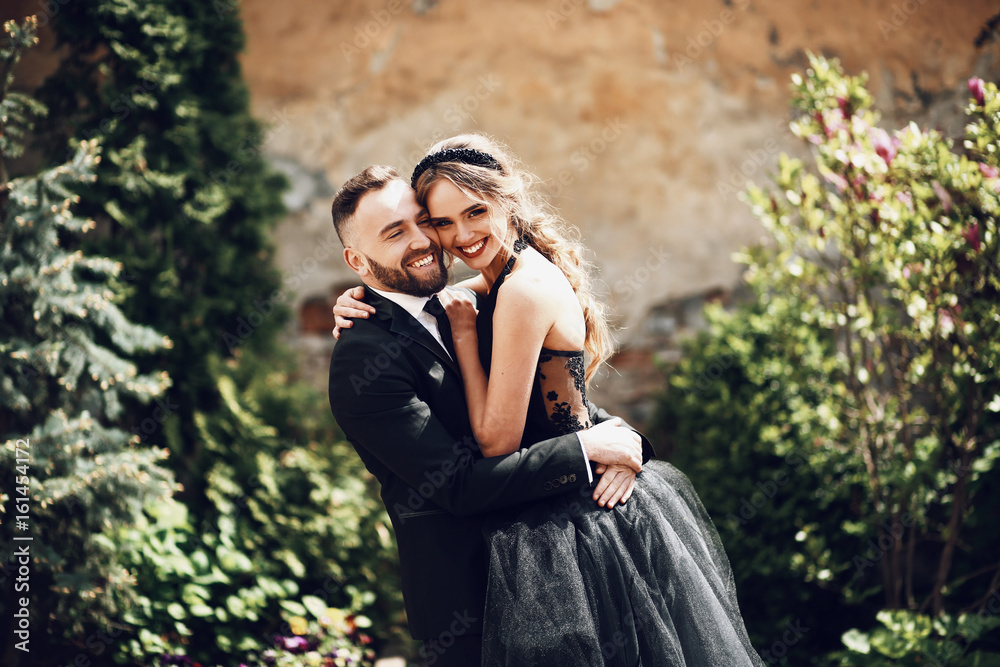 Fototapeta premium Woman leans to her bearded man posing outside