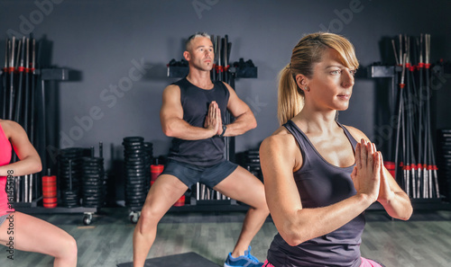 Portrait of blonde woman stretching body in fitness class on sports center