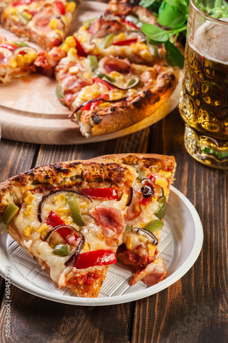 Slices of pizza with bacon, paprika and corn