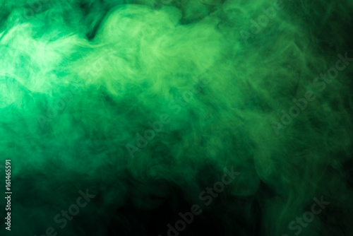 Green smoke on a black background photo