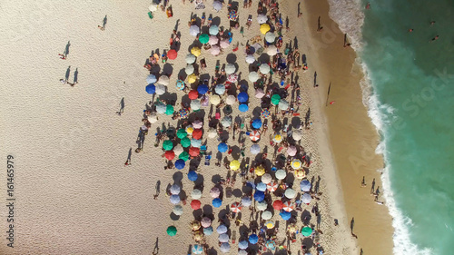 People relaxing on the Ipanema Beach in Rio de Janeiro, Brazil. Top view with ocean