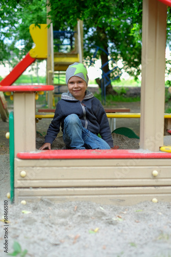 Young boy playing in the sandbox © Maxim