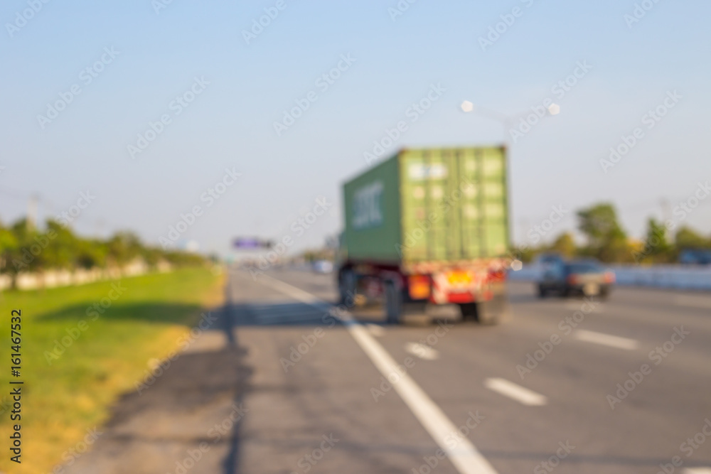 Abstract blurred image of Truck on road. Cargo transportation.