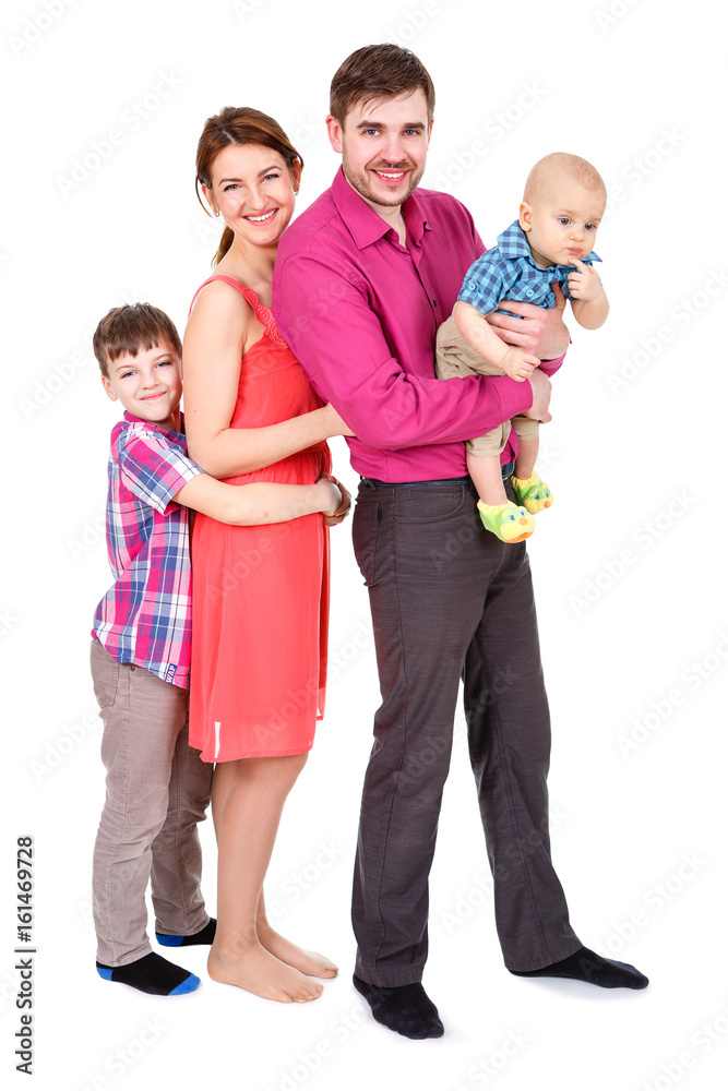 Pretty smiling family looking at the camera. Portrait of a happy four-member family Isolated on White Background. Father and Mother with childrens. Pretty smiling family looking at the camera. Portrait of a happy four-member family Isolated on White Background. Father and Mother with childrens.