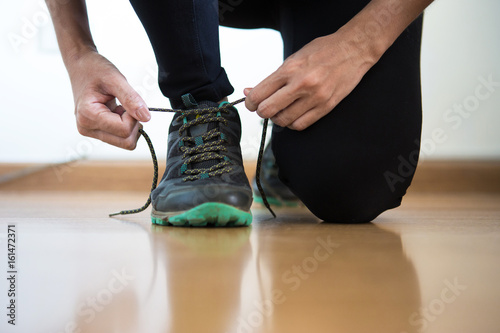 women jogger tying her shoes