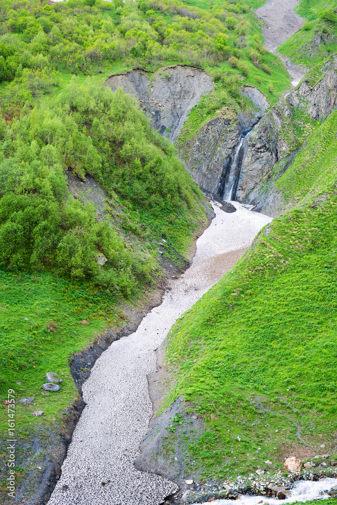 Magical small waterfall in a mountain gorge