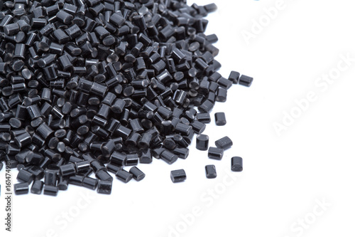 Obraz na płótnie Black plastic polymer granules on white background