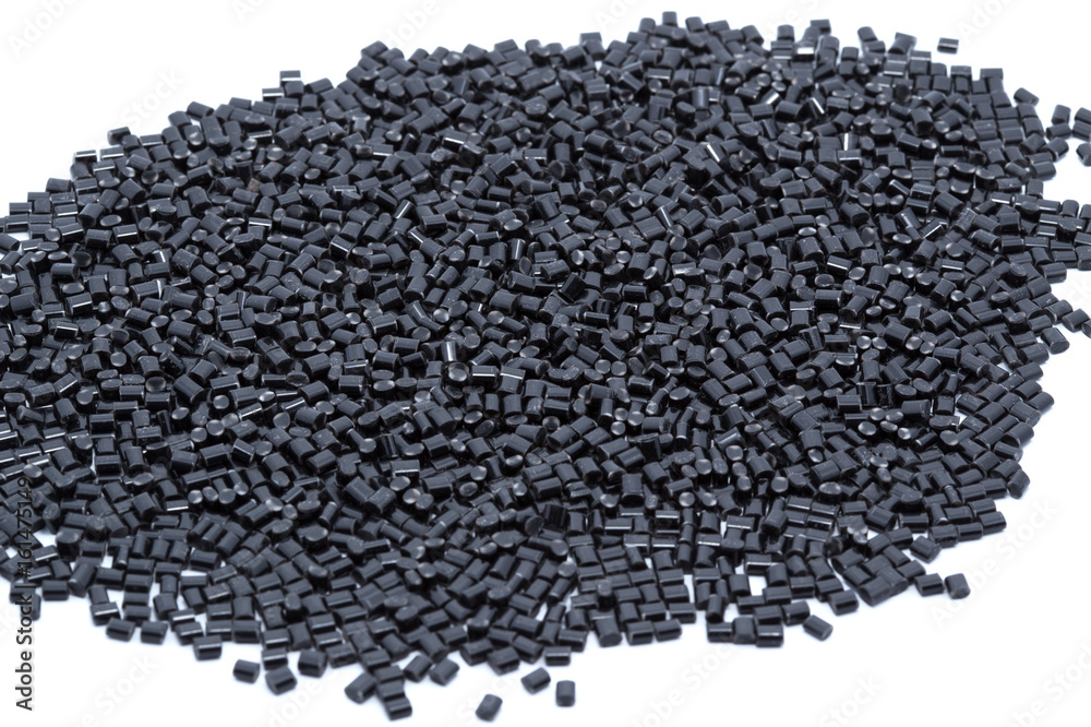 Black plastic polymer granules on white background Black plastic polymer granules on white background
