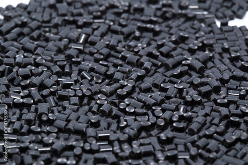 Obraz na płótnie Black plastic polymer granules on white background