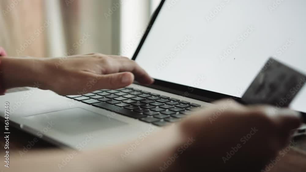 Close up shot of female doing online shopping with credit card Close up shot of female doing online shopping with credit card