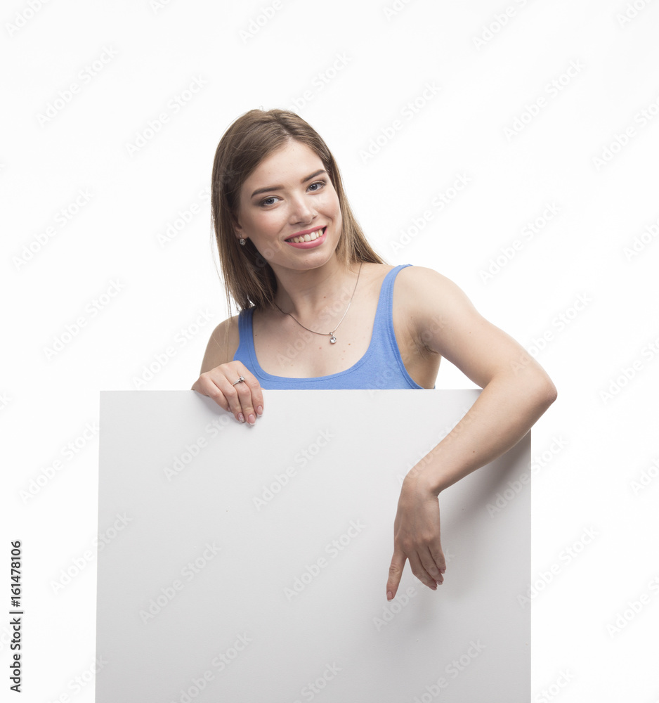 Young happy woman portrait of a confident businesswoman showing presentation, pointing paper placard gray background. Ideal for banners, registration forms, presentation, landings, presenting concept. Young happy woman portrait of a confident businesswoman showing presentation, pointing paper placard gray background. Ideal for banners, registration forms, presentation, landings, presenting concept.