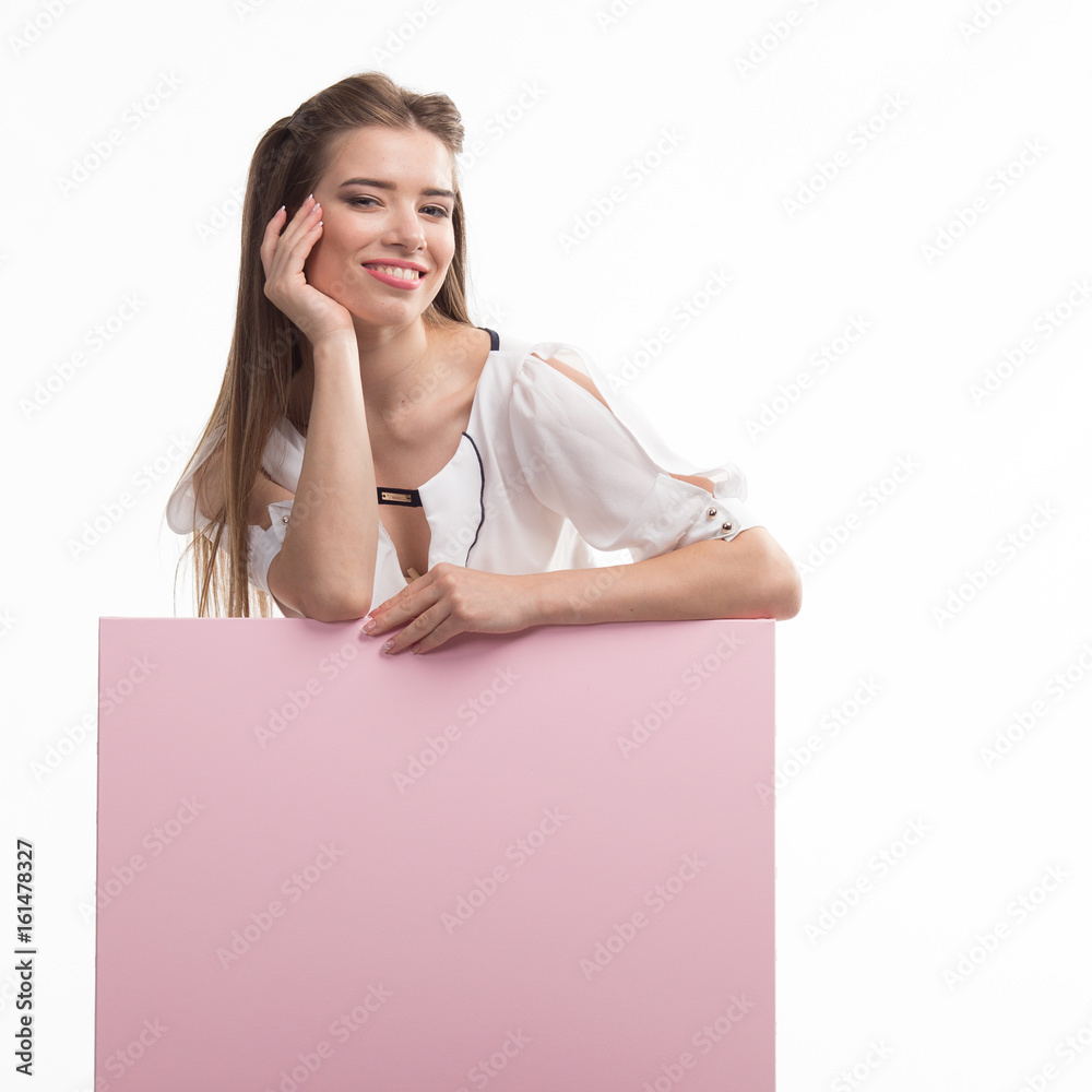 Young happy woman portrait of a confident businesswoman showing presentation, pointing placard pink background. Ideal for banners, registration forms, presentation, landings, presenting concept.. Young happy woman portrait of a confident businesswoman showing presentation, pointing placard pink background. Ideal for banners, registration forms, presentation, landings, presenting concept..