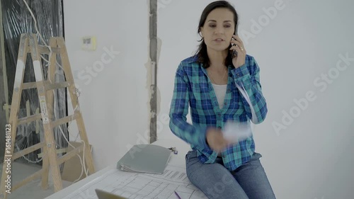 Architect looks irritated while speaking with someone on cellphone about project, steadycam shot

