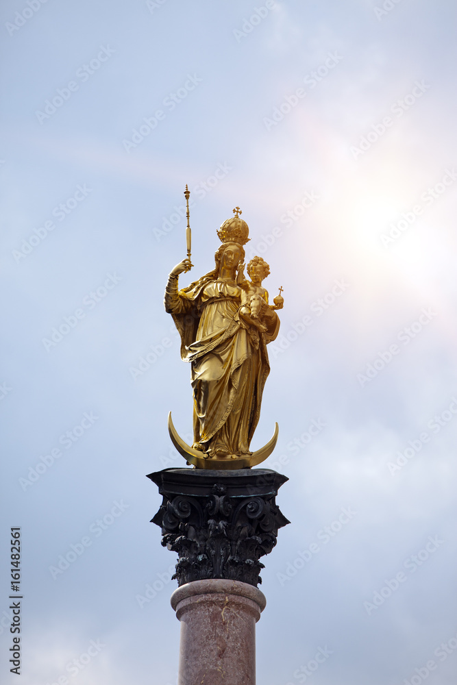 Golden Virgin Mary on the central square Marienplatz in Munich, Germany...