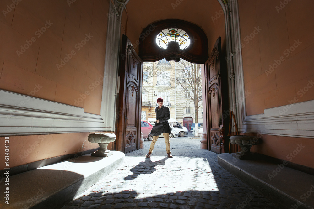 Man stands like a runned in open wooden doors Man stands like a runned in open wooden doors