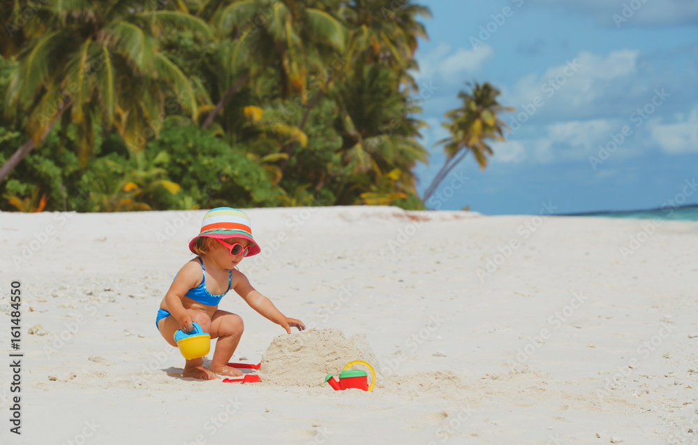 cute little girl play with sand on beach cute little girl play with sand on beach