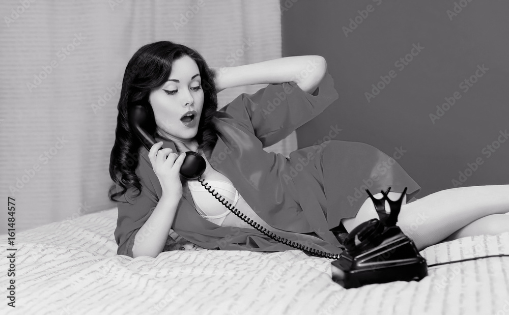 Retro photo sexy woman lying in the bed talks on the vintage telephone,  retro black and white film photo Stock Photo | Adobe Stock
