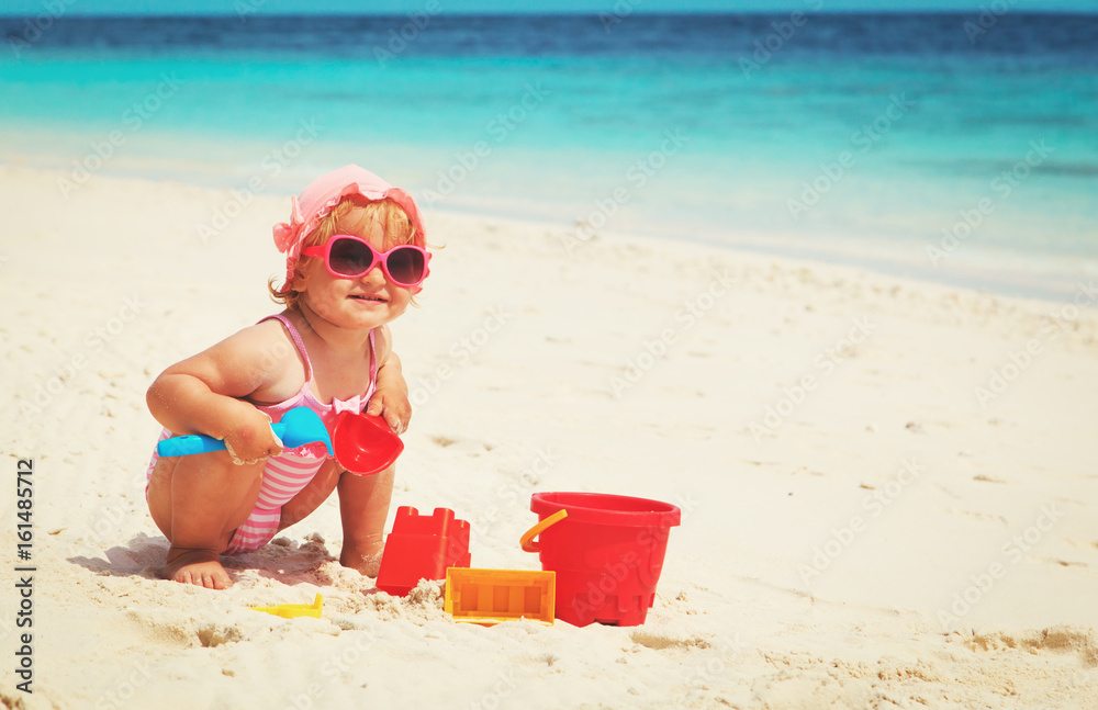 little girl play with sand on beach little girl play with sand on beach