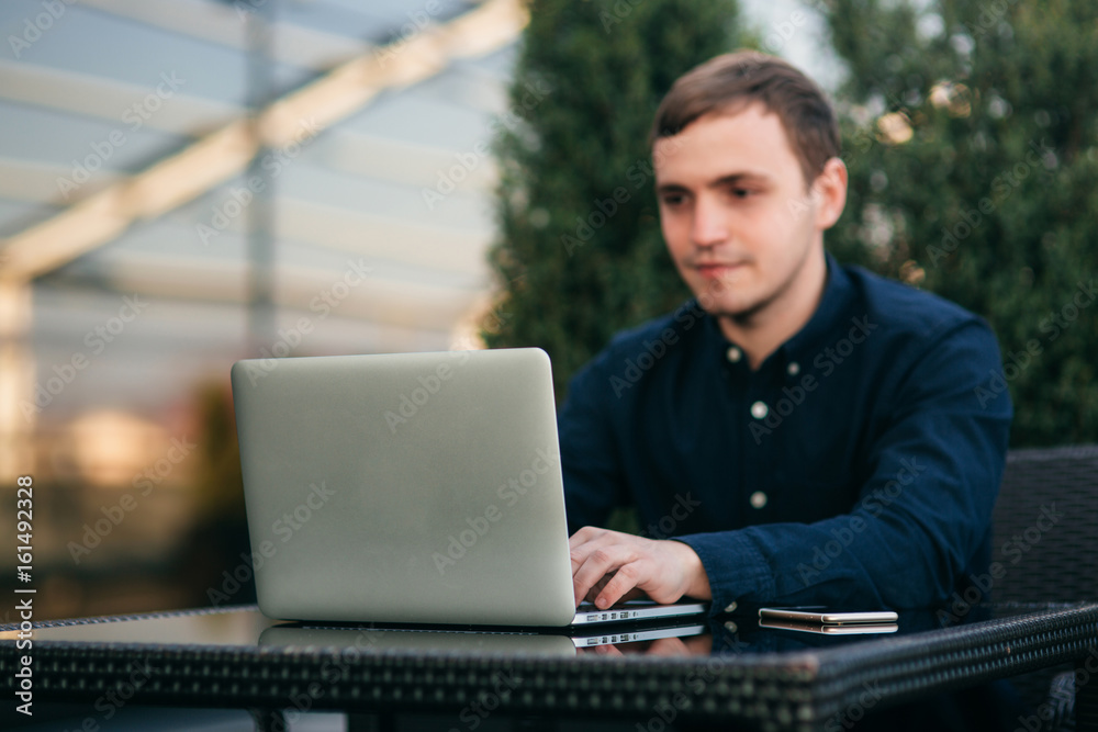 The young bank employee works on a laptop at lunchtime. The young bank employee works on a laptop at lunchtime.