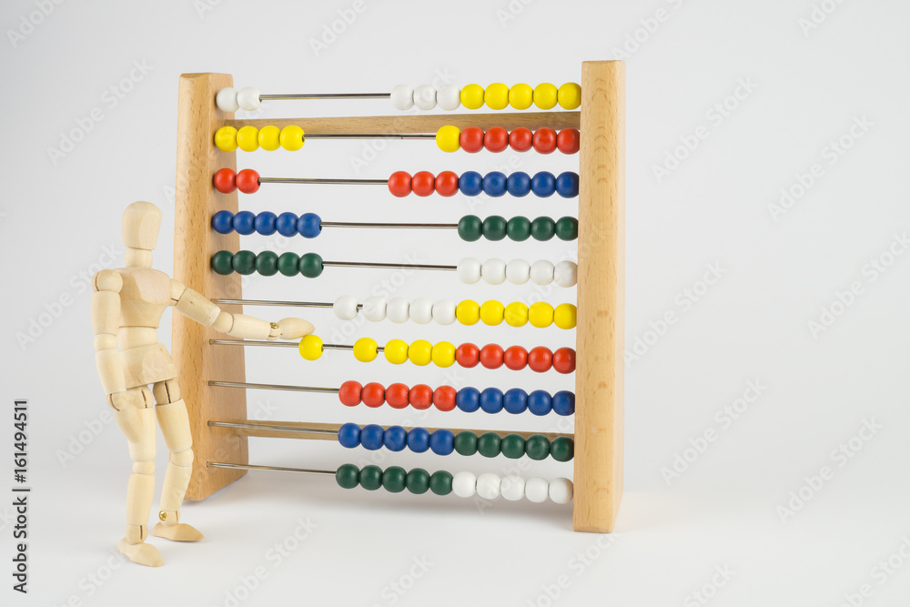 Ein Abakus mit einer Holzfigur, die die Kugeln verschiebt, viel Textfreiraum Ein Abakus mit einer Holzfigur, die die Kugeln verschiebt, viel Textfreiraum