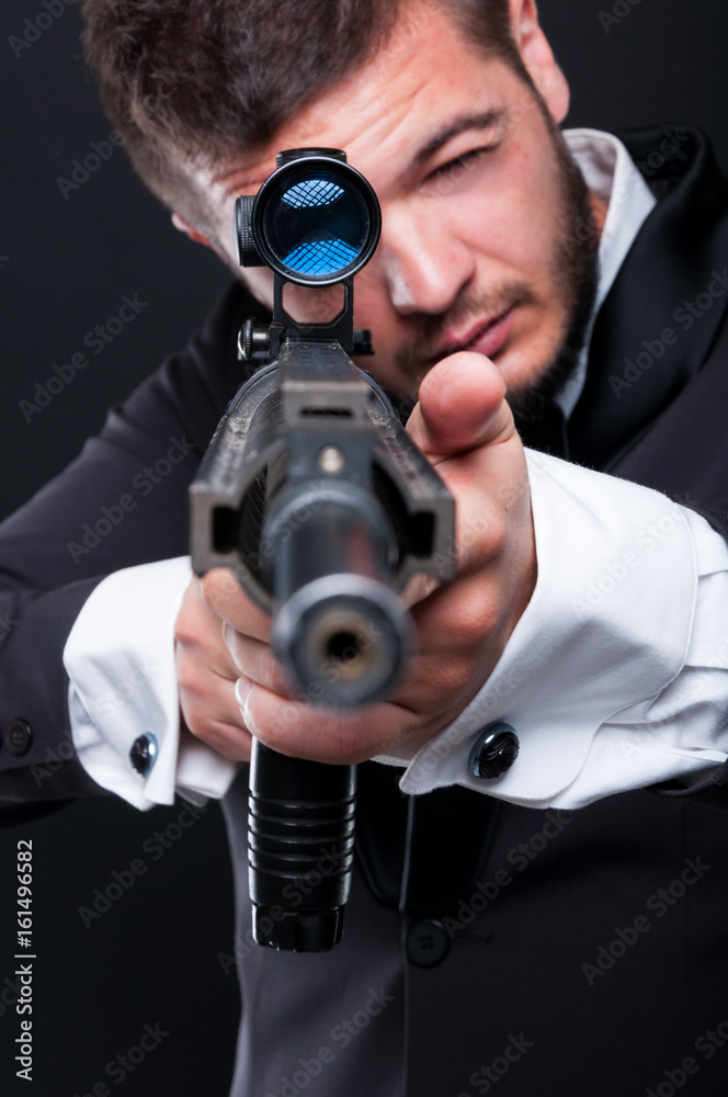 Mafia guy pointing at the camera with firearm