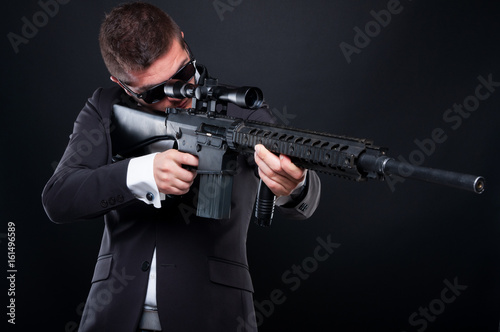 Male gangster aiming machine gun at someone