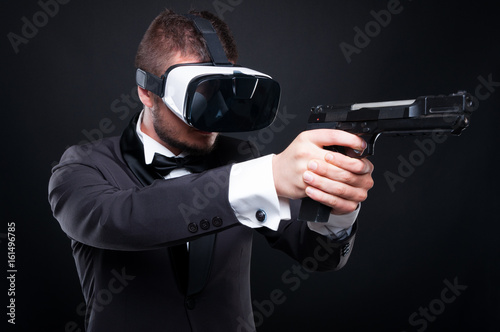 Dangerous man with a gun and vr goggles