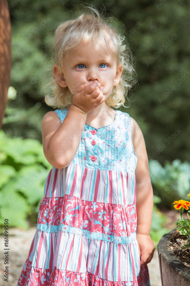 Frighten face of a baby girl. Portrait of a blond child Frighten face of a baby girl. Portrait of a blond child