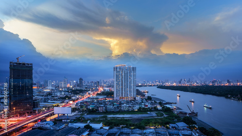 Cityscape of Bangkok in twilight viewing Rama III road along Chao Phraya river , Thailand