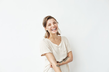 Cheerful happy young beautiful girl looking at camera smiling laughing over white background.
