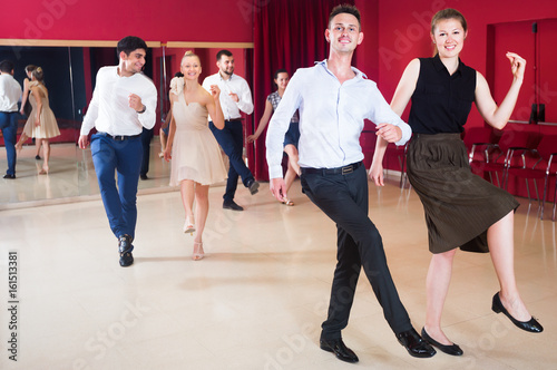 Adult people practicing vigorous jive movements