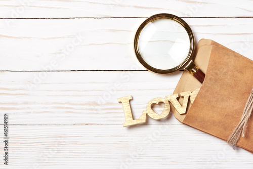 Retro envelope and word Love on wooden background