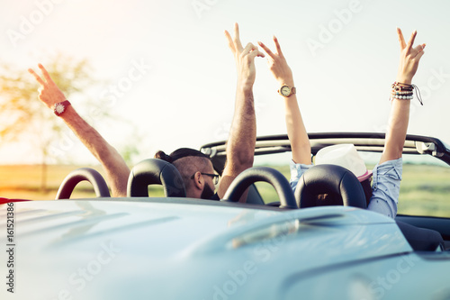 Happy young people in convertible car