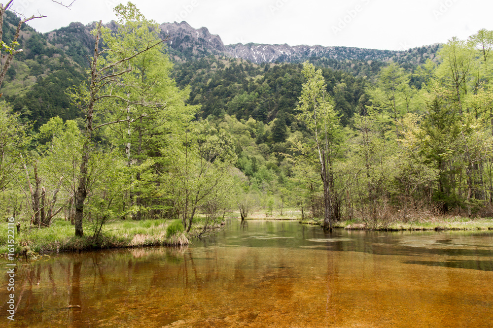 Hotaka mountain range and taisho ike pond in spring at kamikochi national park nagano japan Hotaka mountain range and taisho ike pond in spring at kamikochi national park nagano japan