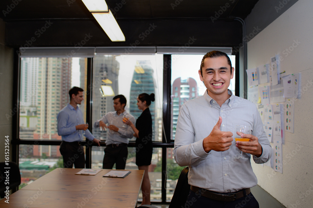 handsome businessman smile and showing thumbs up in the office, business success concept handsome businessman smile and showing thumbs up in the office, business success concept