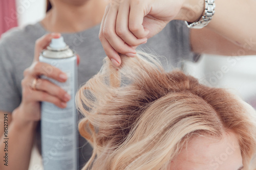 Wallpaper Mural Hair stylist makes a curls for a girl, using hair styling. Hairdresser at work. Torontodigital.ca