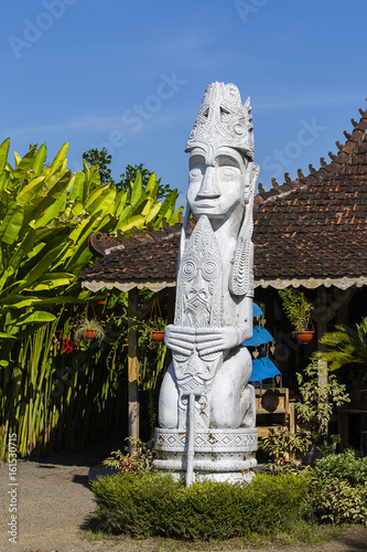 Balinese white statue of the spirit next to the house. Ubud, island Bali, Indonesia