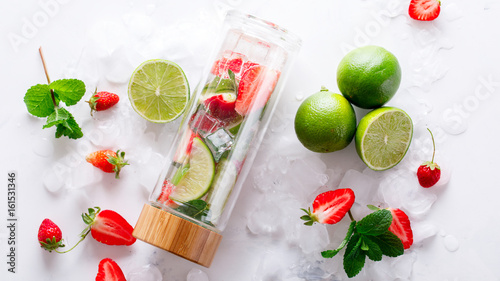 Drink with ice  berries  citrus and mint. Detox. Strawberry.  lime. Mojito in a glass bottle.Food or Healthy diet concept.Super Food.Vegetarian.Copy space for Text.selective focus.