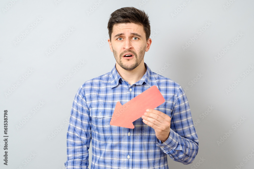 Man with red arrow pointing to the left and down Man with red arrow pointing to the left and down