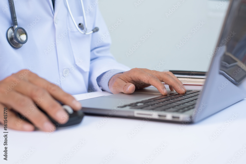 Doctor working on laptop computer