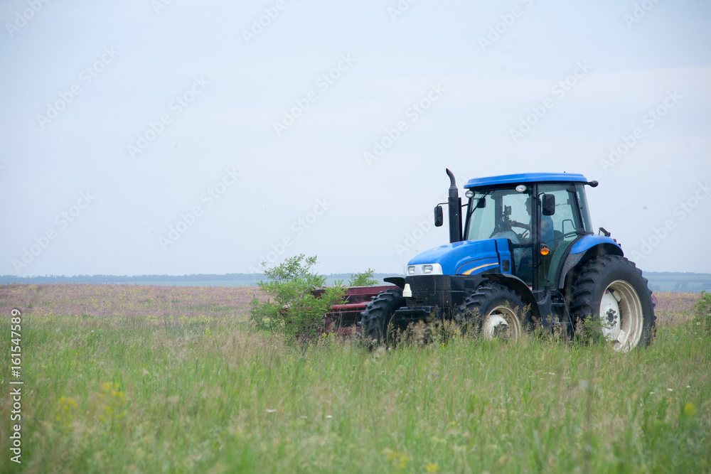 pasture mowing with blue tractor and mower pasture mowing with blue tractor and mower