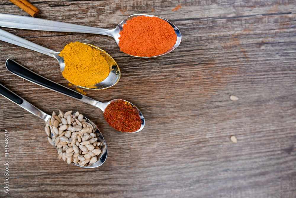 Various spices spoons on stone table. Top view with copy space Various spices spoons on stone table. Top view with copy space