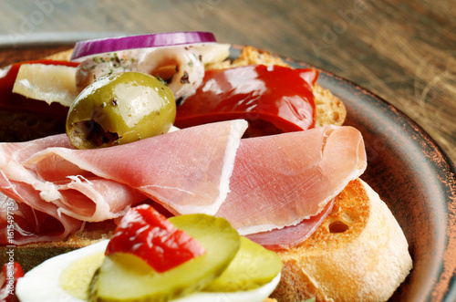 Sandwiches with salmon, mussels, jamon and olives